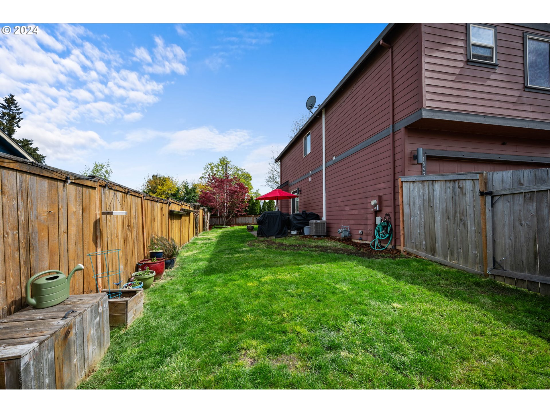 18438 Shadow Ridge Way Oregon City, OR 97045 - Photo 32 of 38 a view of a backyard with potted plants and wooden fence