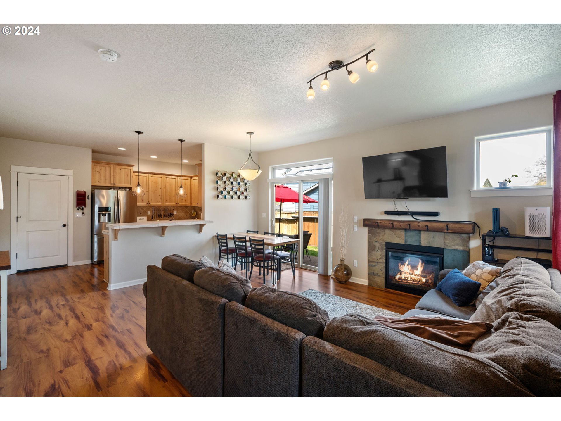 18438 Shadow Ridge Way Oregon City, OR 97045 - Photo 5 of 38 a living room with furniture a fireplace and a flat screen tv