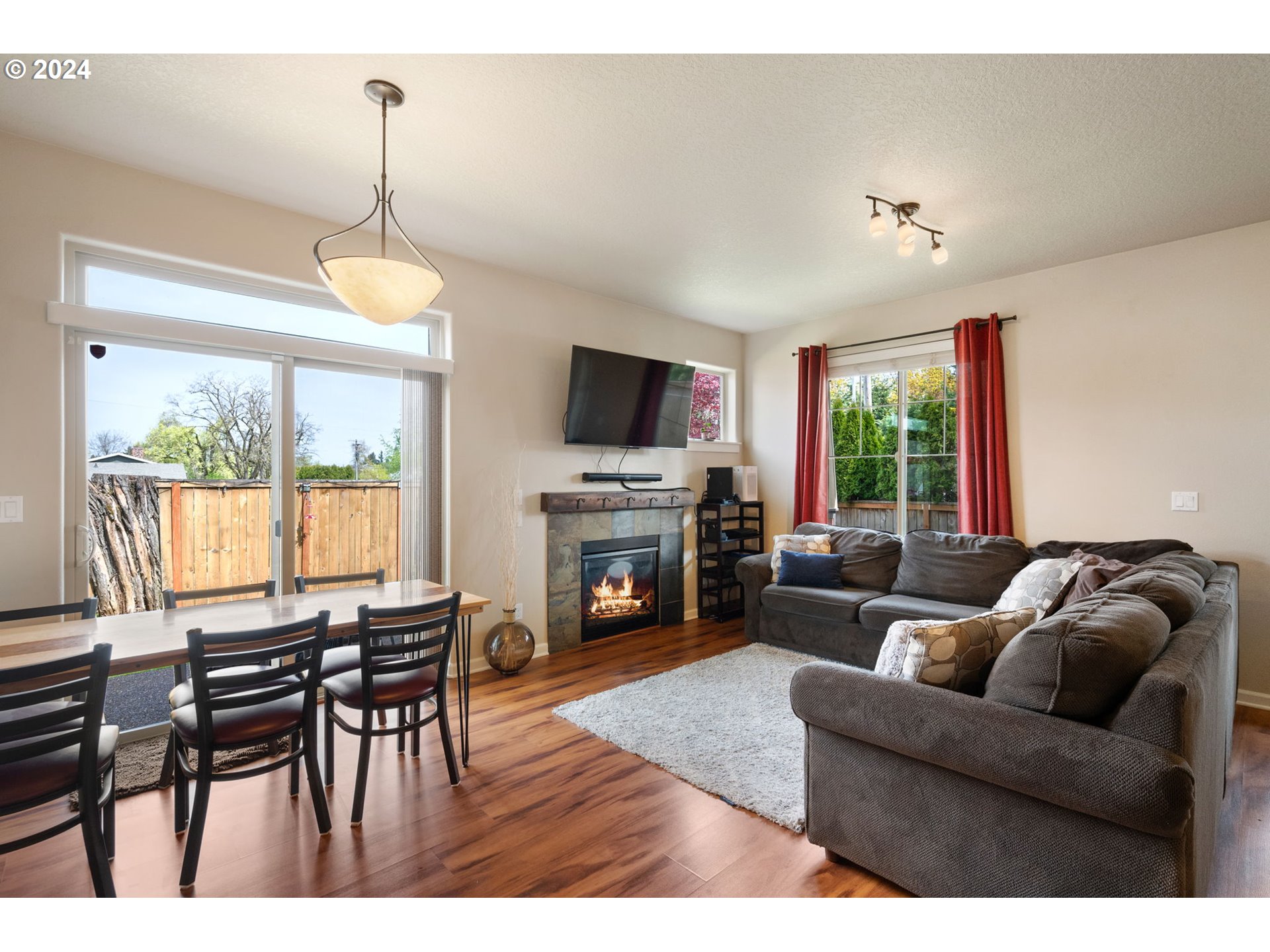 18438 Shadow Ridge Way Oregon City, OR 97045 - Photo 7 of 38 a living room with furniture a fireplace and a flat screen tv