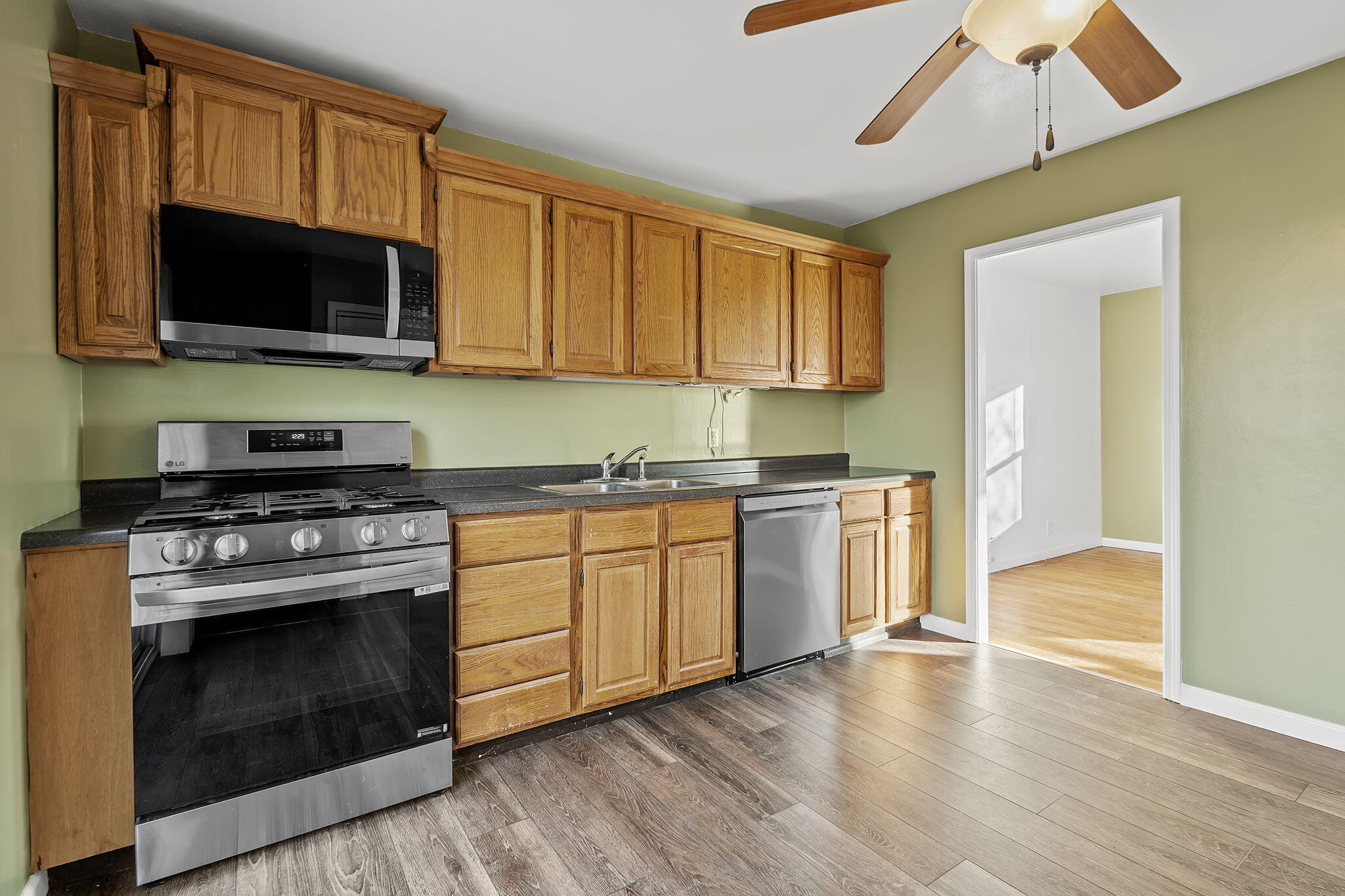 522 West Parks Drive Rensselaer, IN 47978 - Photo 12 of 29 a kitchen with stainless steel appliances granite countertop a stove a microwave oven cabinets and wooden floor