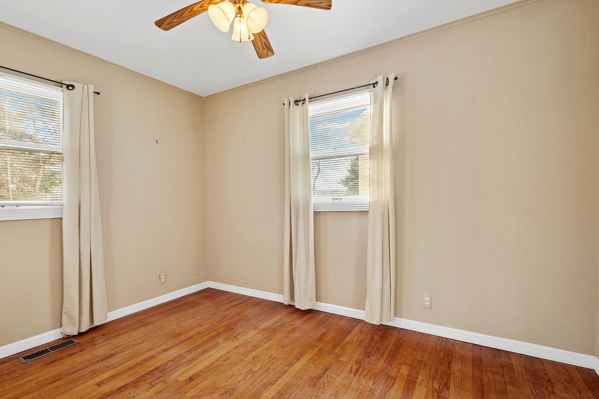 522 West Parks Drive Rensselaer, IN 47978 - Photo 16 of 29 an empty room with wooden floor fan and windows