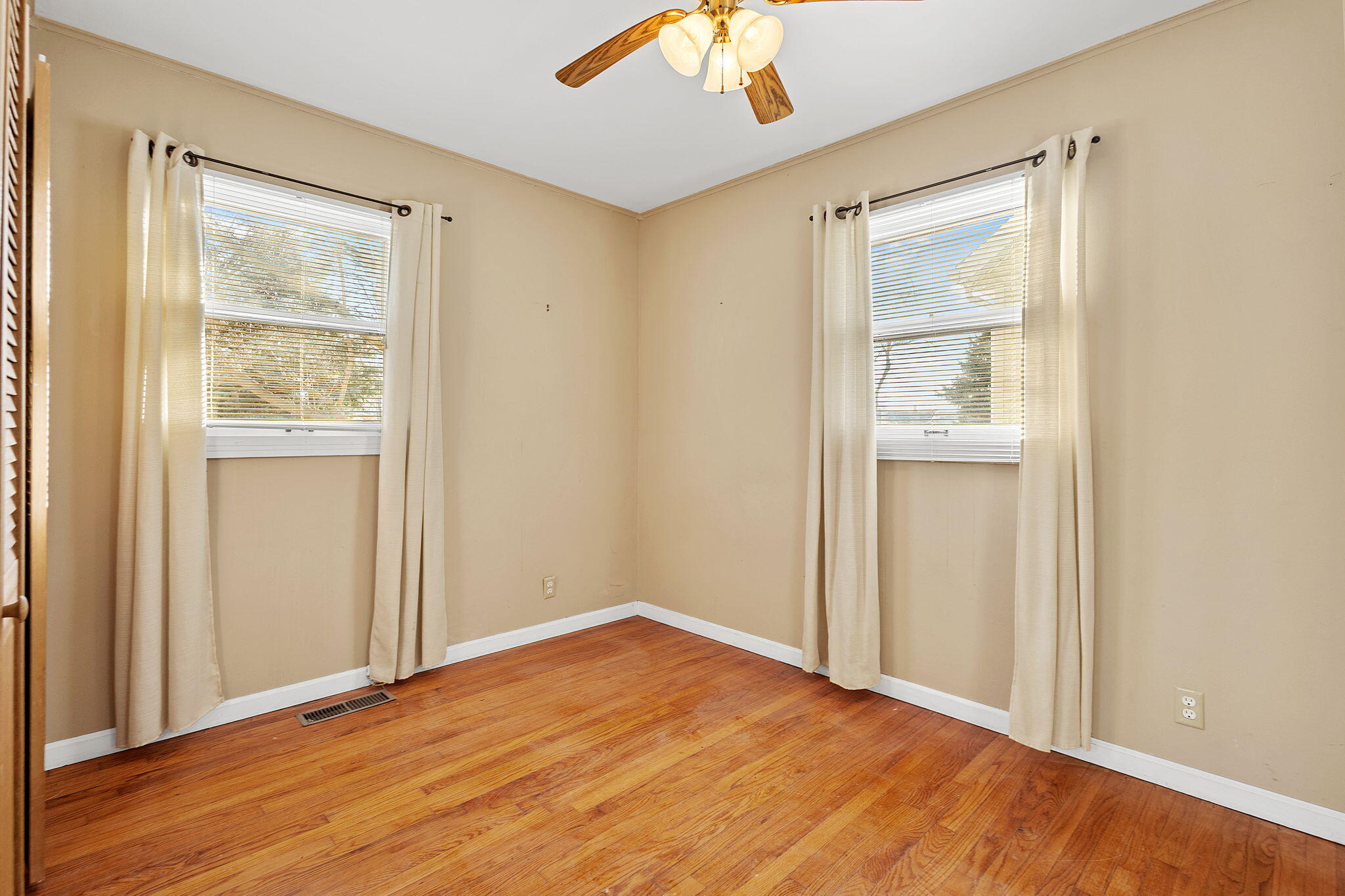 522 West Parks Drive Rensselaer, IN 47978 - Photo 17 of 29 an empty room with wooden floor and windows