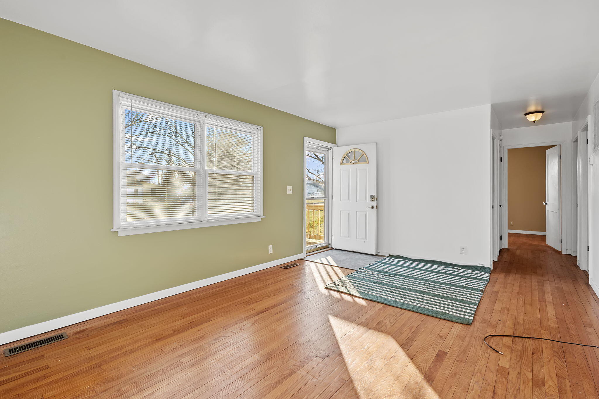 522 West Parks Drive Rensselaer, IN 47978 - Photo 7 of 29 a view of an empty room with wooden floor and a window