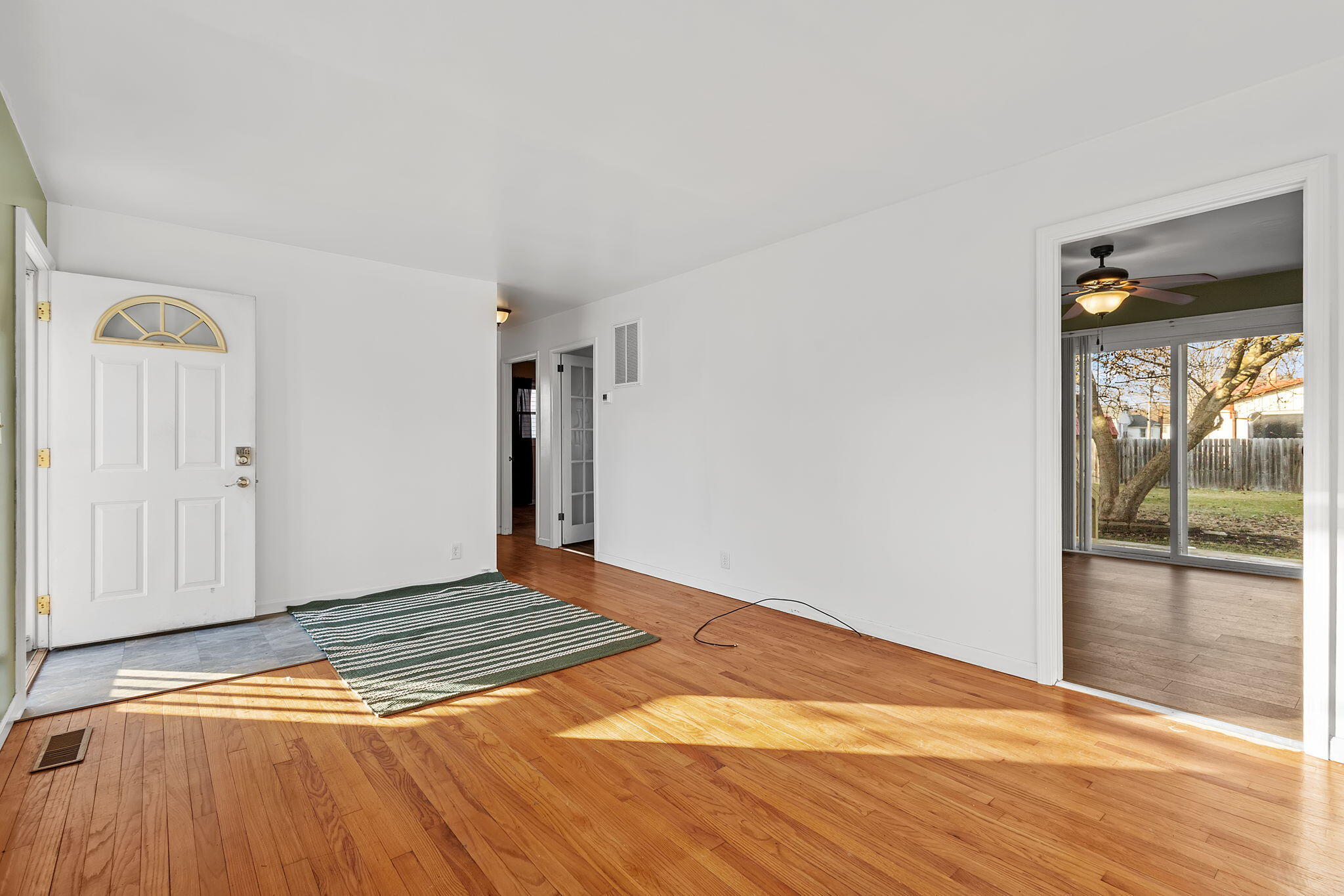 522 West Parks Drive Rensselaer, IN 47978 - Photo 8 of 29 a view of an empty room with wooden floor and a window