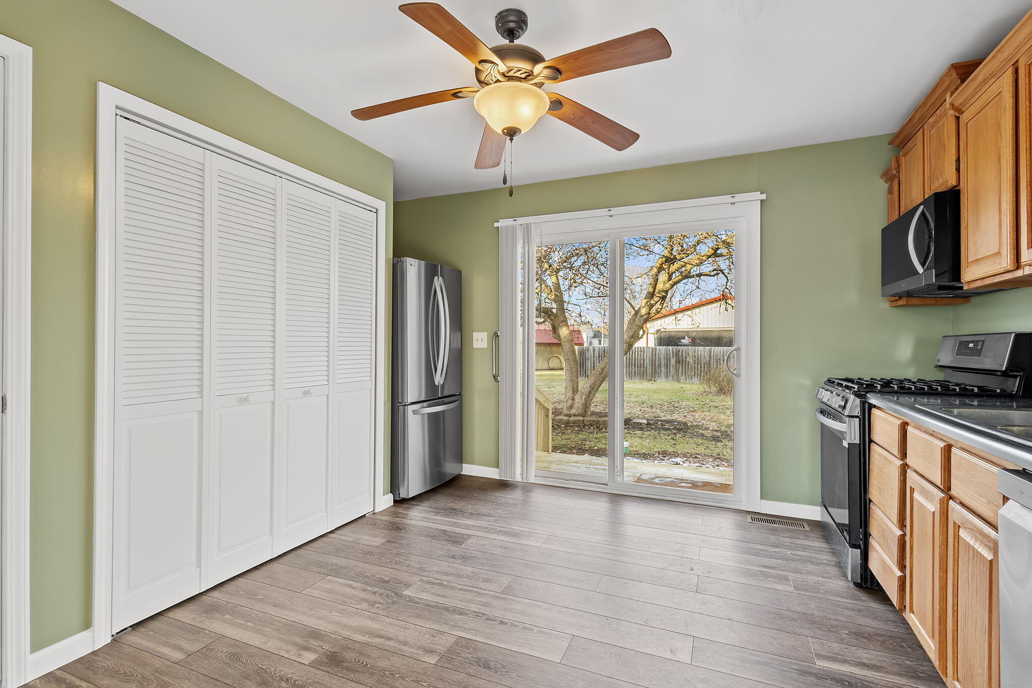 522 West Parks Drive Rensselaer, IN 47978 - Photo 9 of 29 a view of a kitchen with wooden floor and a ceiling fan