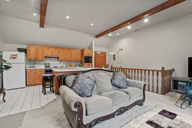 a living room with furniture a couch and a flat screen tv