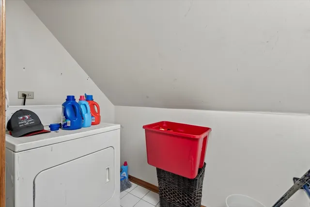 a front view of a house with a garden and trees