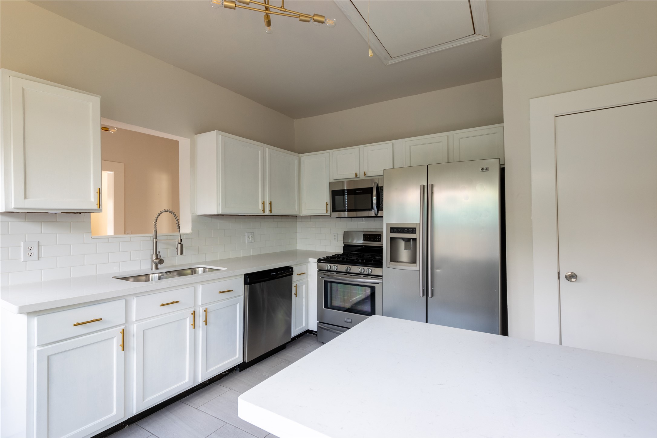 2009 Singleton Street Houston, TX 77008 - Photo 12 of 24 a kitchen with cabinets stainless steel appliances and sink