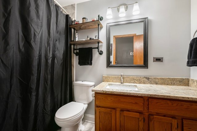 172 Oxford Road Bolingbrook, IL 60440 - Photo 17 of 27 a bathroom with a granite countertop sink toilet and mirror