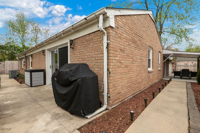 172 Oxford Road Bolingbrook, IL 60440 - Photo 24 of 27 a view of a house with a barbeque and large trees