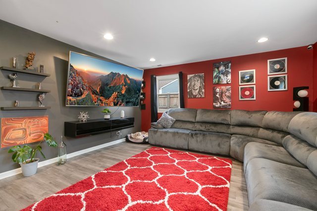 172 Oxford Road Bolingbrook, IL 60440 - Photo 4 of 27 a living room with furniture and a flat screen tv