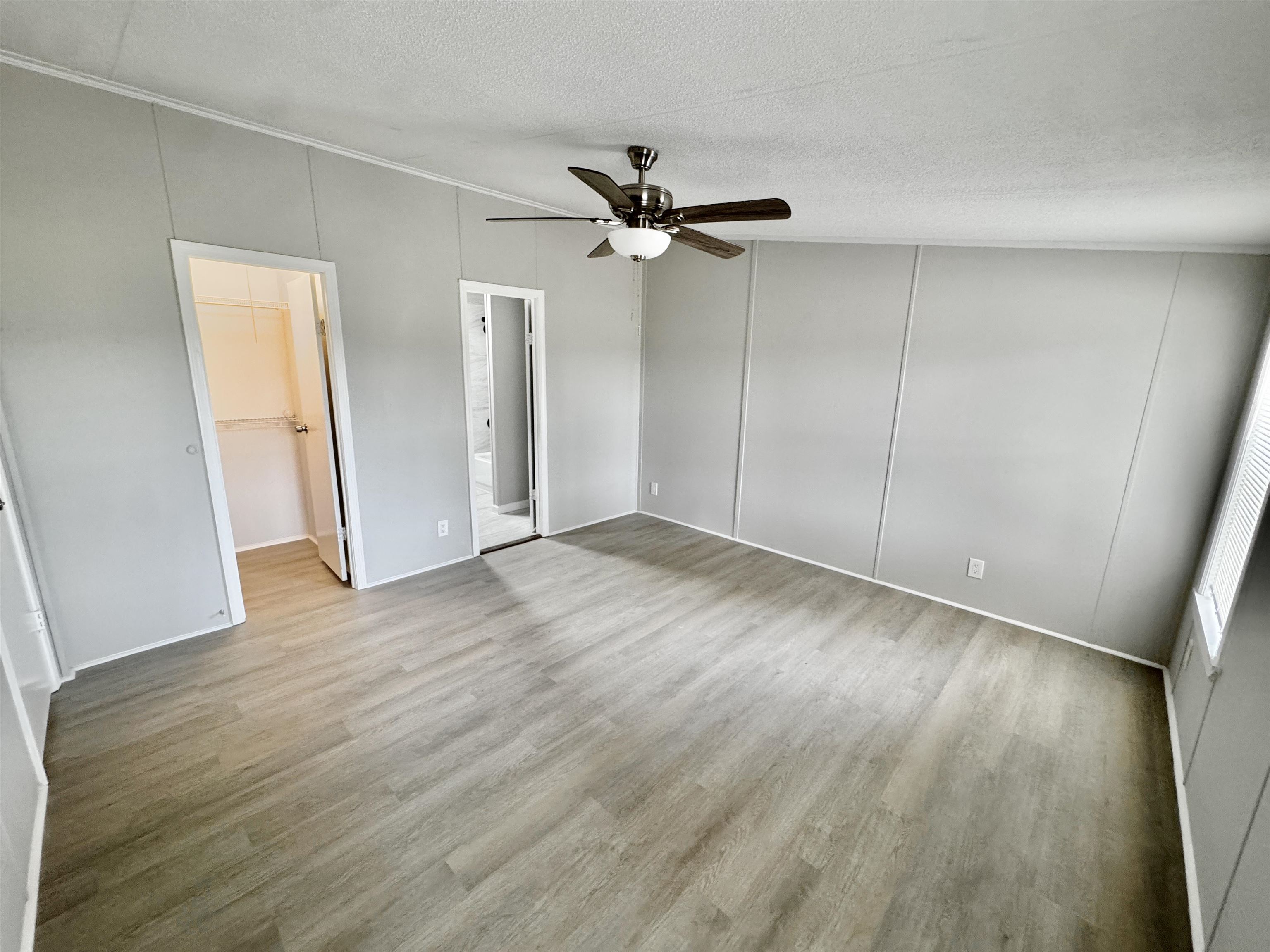 3178 Portersville Road Atoka, TN 38004 - Photo 15 of 31 an empty room with wooden floor fan and windows