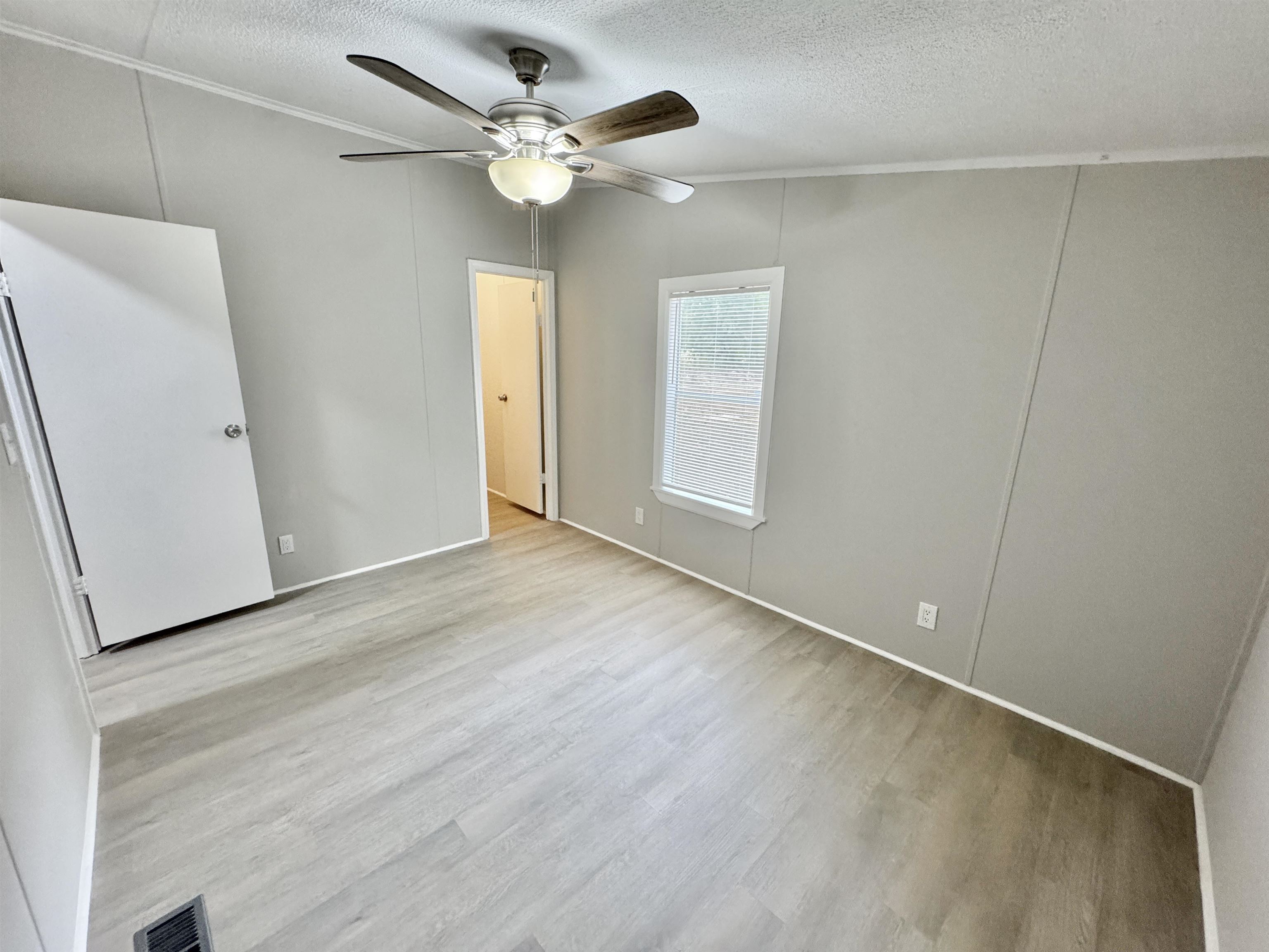 3178 Portersville Road Atoka, TN 38004 - Photo 19 of 31 wooden floor in an empty room with a window