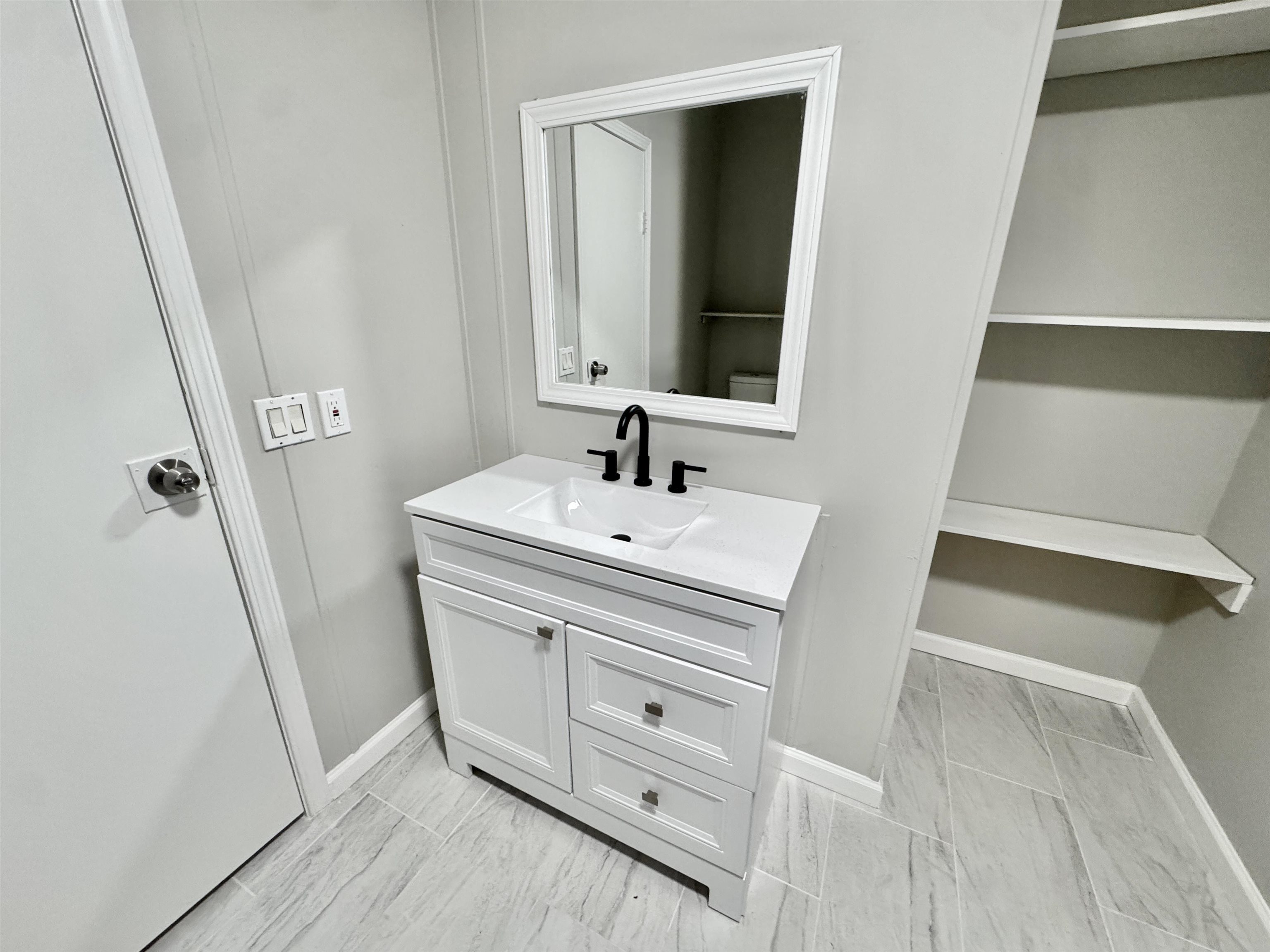 3178 Portersville Road Atoka, TN 38004 - Photo 21 of 31 a bathroom with a sink and a mirror