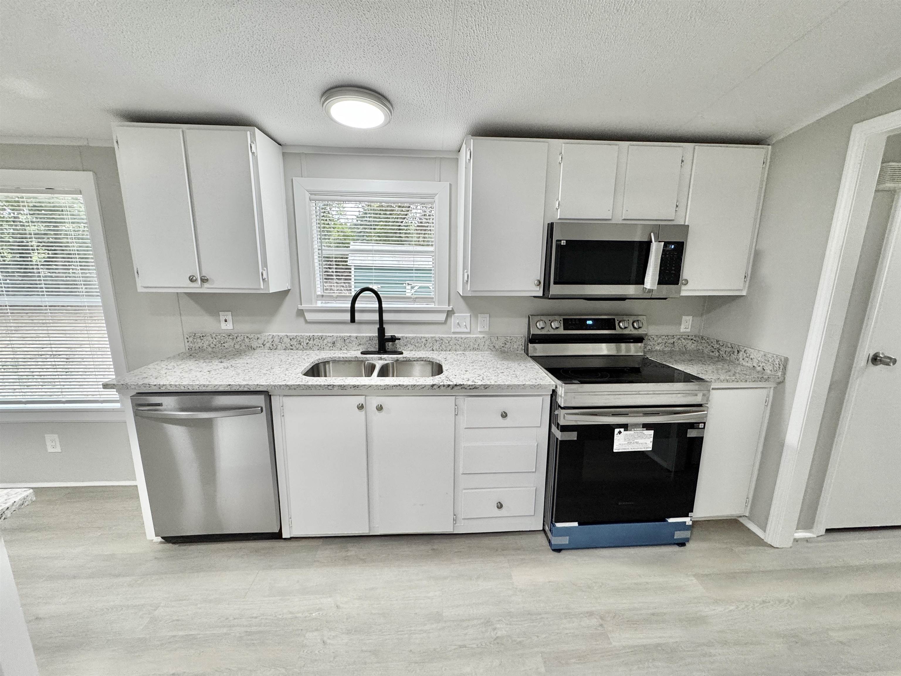 3178 Portersville Road Atoka, TN 38004 - Photo 5 of 31 a kitchen with stainless steel appliances a stove a microwave a sink and a microwave