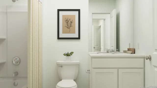 a bathroom with a toilet sink vanity and mirror