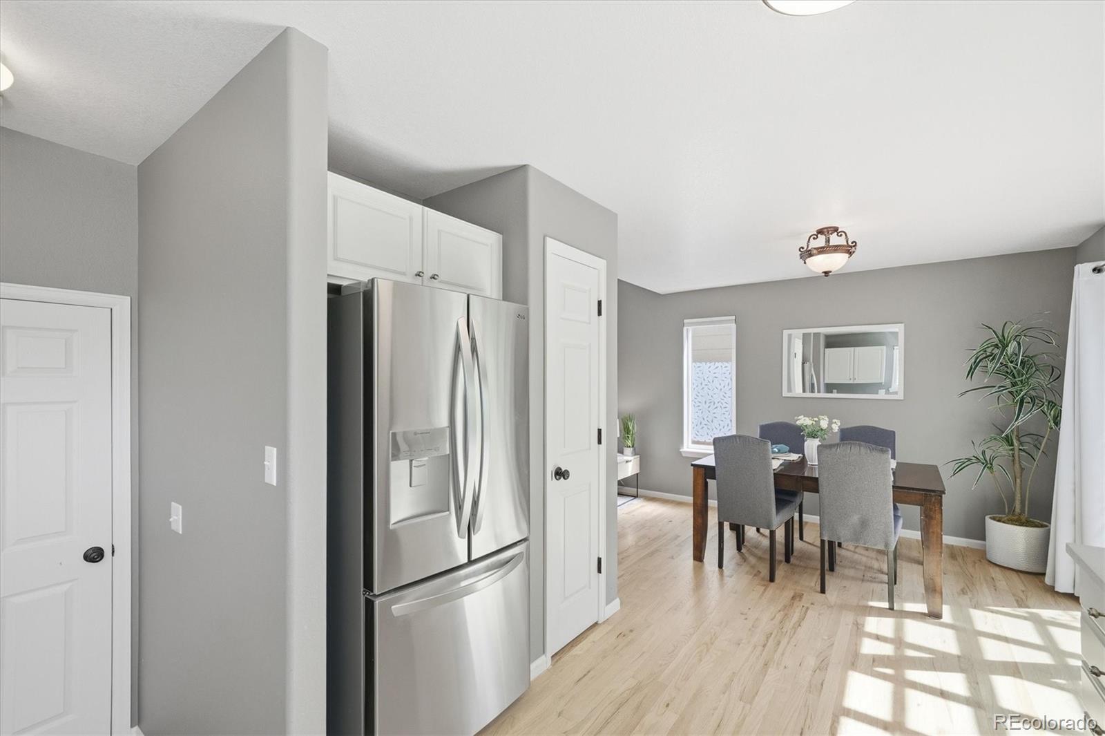 9629 Burberry Way Highlands Ranch, CO 80129 - Photo 18 of 50 a kitchen with stainless steel appliances a refrigerator and dining table