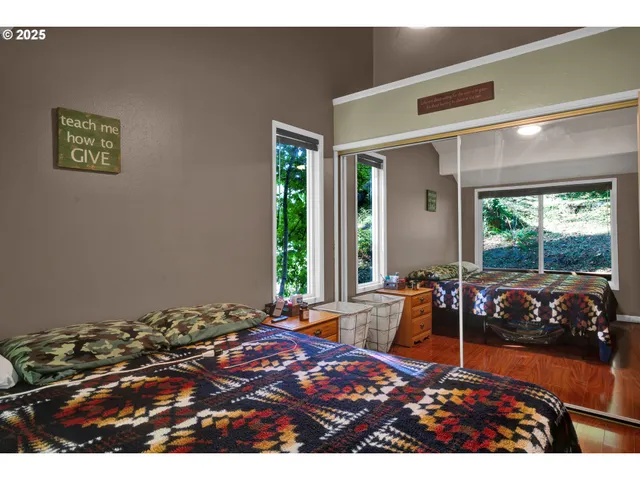 a bedroom with furniture and large windows