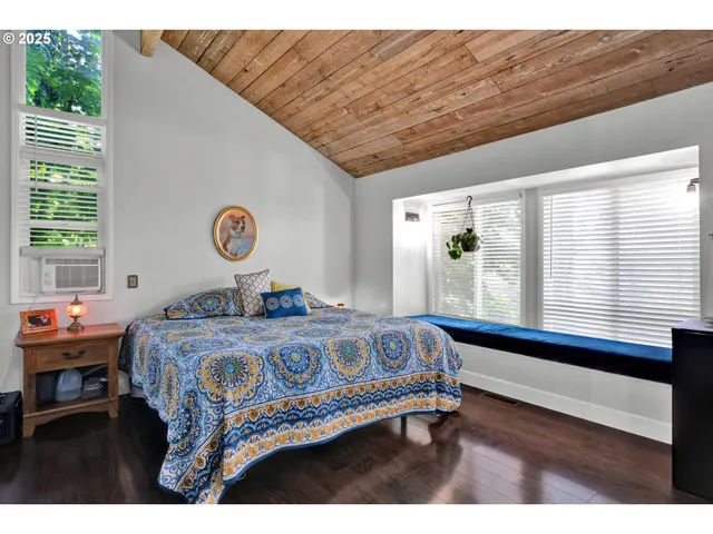 a bed sitting in a bedroom next to a window