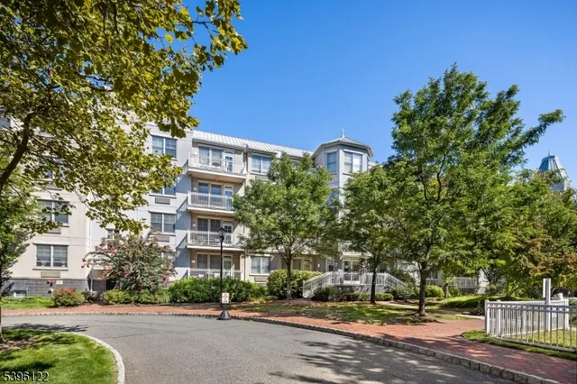 a front view of a building with tree s