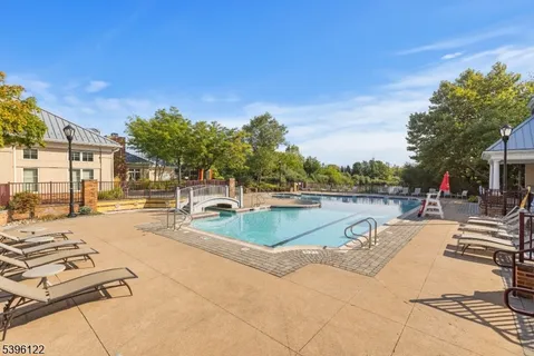 a view of a swimming pool and lounge chairs