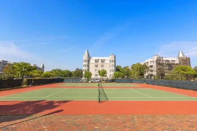 a park with lots of trees and buildings in the background