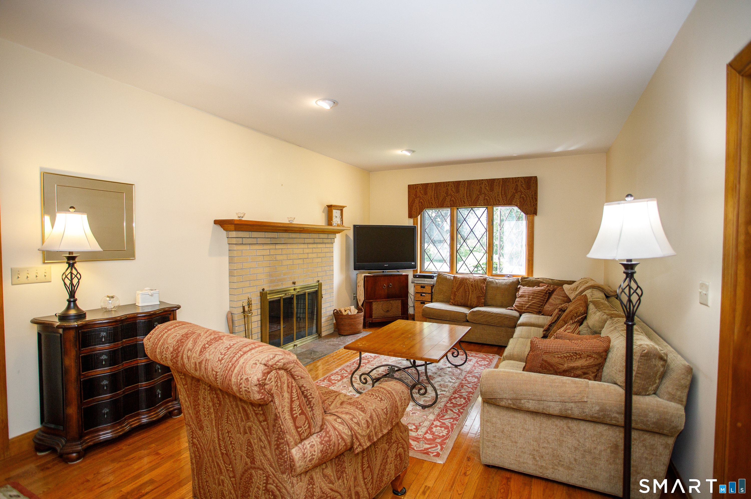 25 Stony Ridge Road Norwich, CT 06360 - Photo 16 of 40 a living room with furniture fireplace and a flat screen tv