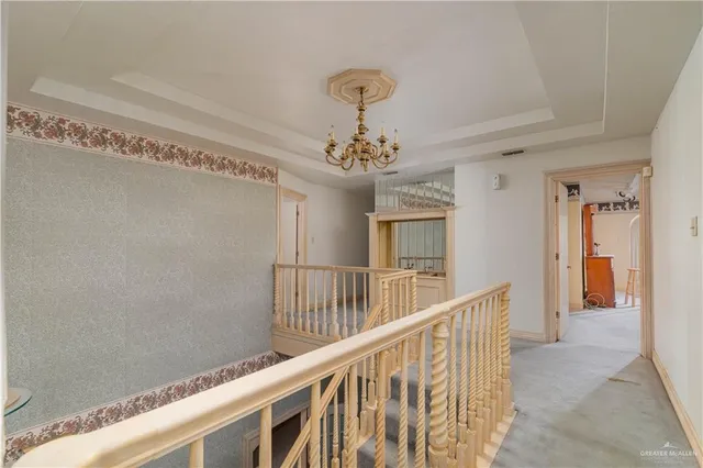 a view of a hallway with a chandelier