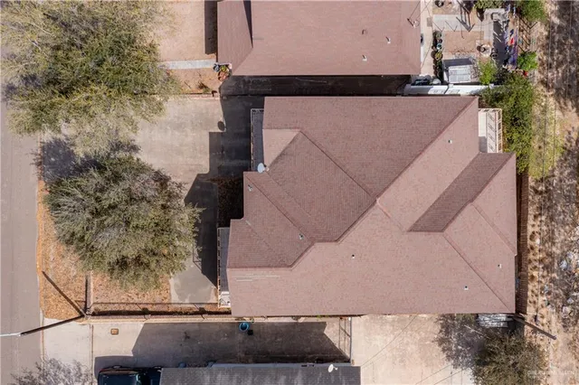 an aerial view of a house with a yard