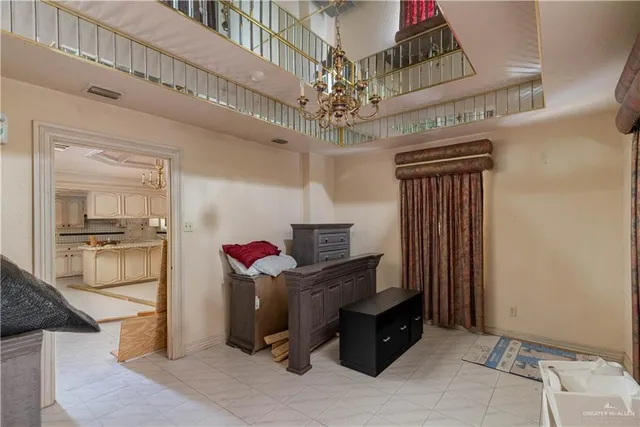 a living room with furniture and a chandelier
