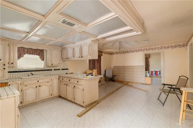 a kitchen with sink and cabinets