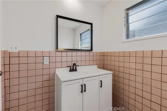 a bathroom with a sink and mirror