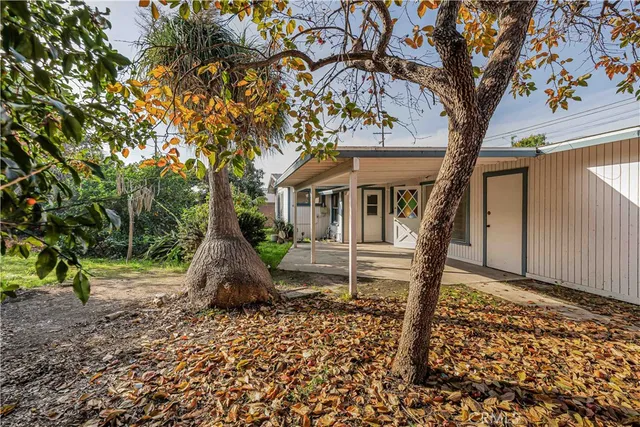 a view of house with a tree in the background