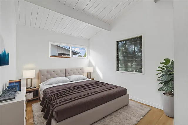 a bedroom with a bed and a window