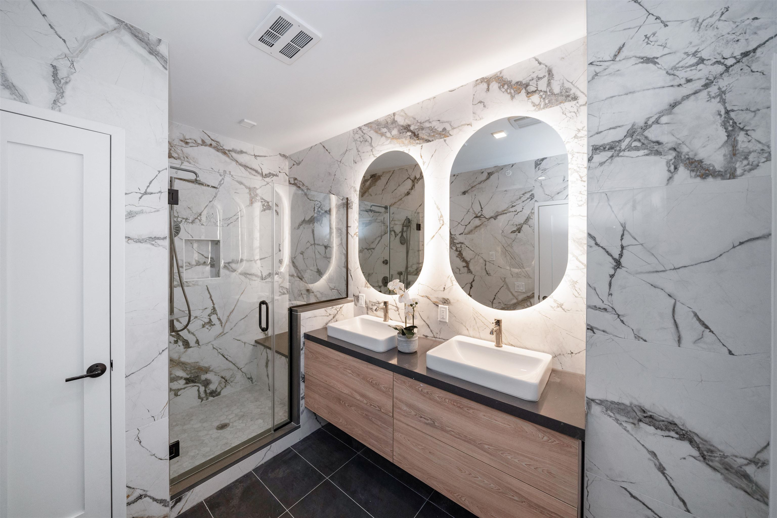 7101 River Road, Unit 202B North Bergen, NJ 07047 - Photo 17 of 26 a bathroom with a double vanity sink mirror and shower