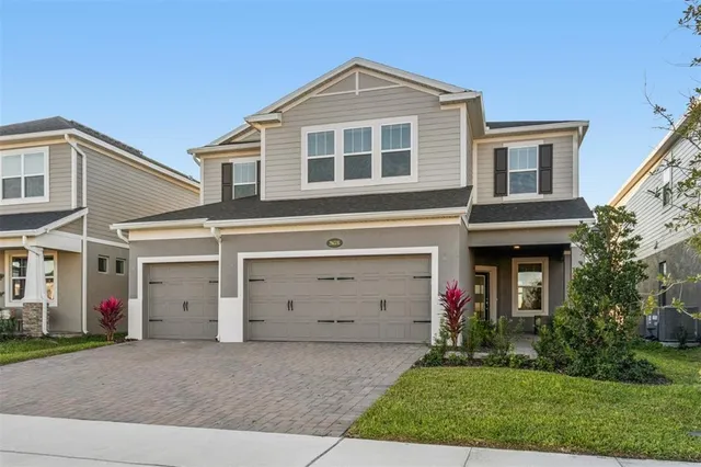 a front view of a house with a yard and garage
