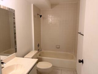 7473 Champagne Place Boca Raton, FL 33433 - Photo 13 of 27 a bathroom with a toilet a sink and bathtub
