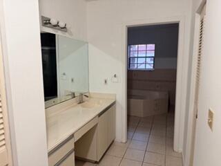 7473 Champagne Place Boca Raton, FL 33433 - Photo 15 of 27 a bathroom with a granite countertop sink and a mirror