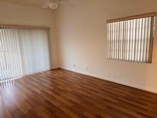 7473 Champagne Place Boca Raton, FL 33433 - Photo 16 of 27 an empty room with wooden floor and windows