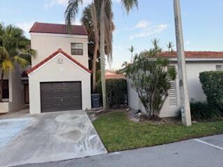 7473 Champagne Place Boca Raton, FL 33433 - Photo 25 of 27 a front view of a house with garden