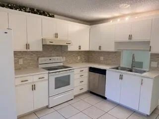 a kitchen with cabinets appliances and a sink