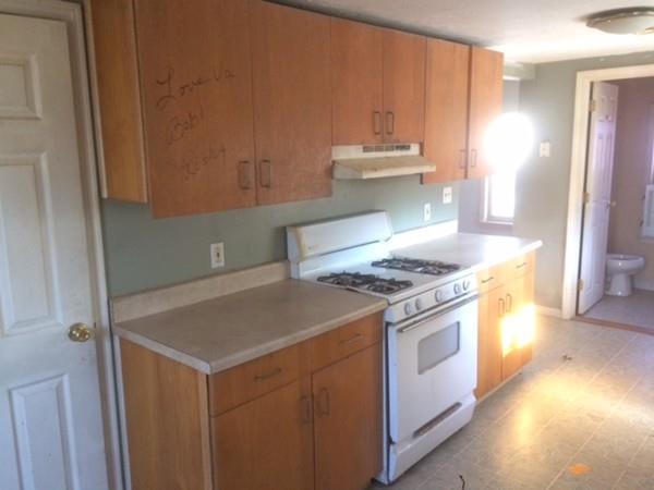 18 Salt Works Road Wareham, MA 02532 - Photo 7 of 11 a kitchen with a stove and a refrigerator
