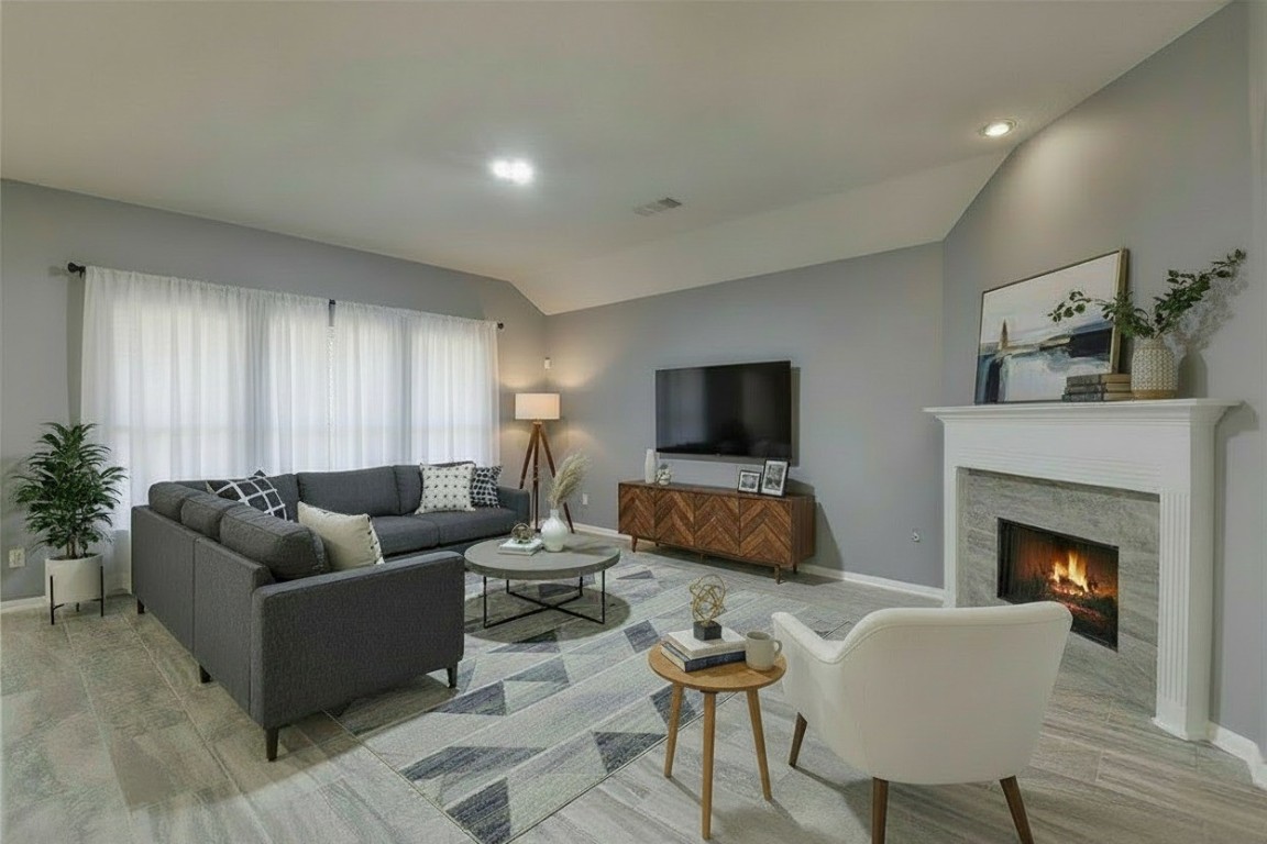 18411 Atasca Wds Trace Humble, TX 77346 - Photo 12 of 44 a living room with furniture a flat screen tv and a fireplace