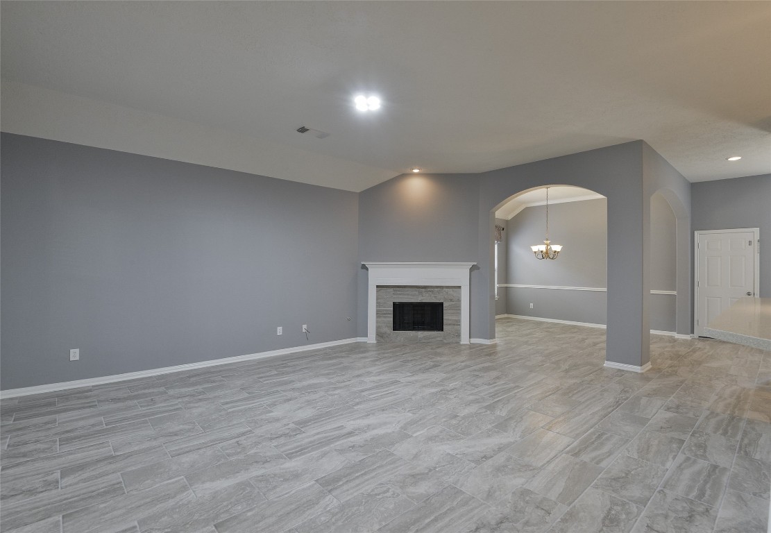 18411 Atasca Wds Trace Humble, TX 77346 - Photo 13 of 44 an empty room with wooden floor and fireplace