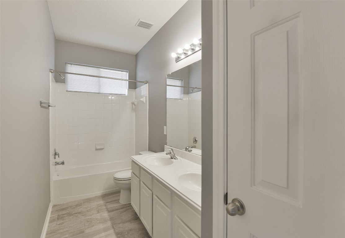 18411 Atasca Wds Trace Humble, TX 77346 - Photo 32 of 44 a bathroom with a granite countertop sink a toilet and shower