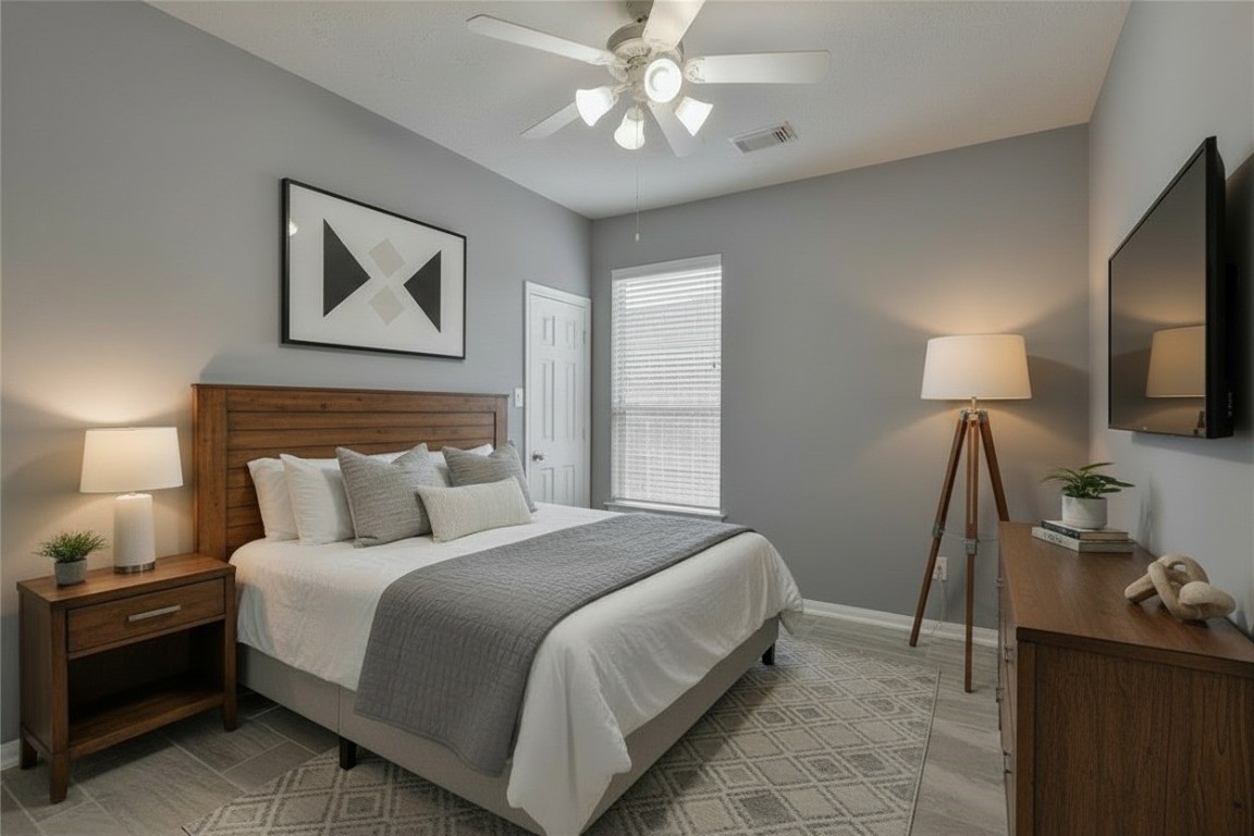 18411 Atasca Wds Trace Humble, TX 77346 - Photo 34 of 44 a bedroom with a bed and a flat tv screen on the dresser