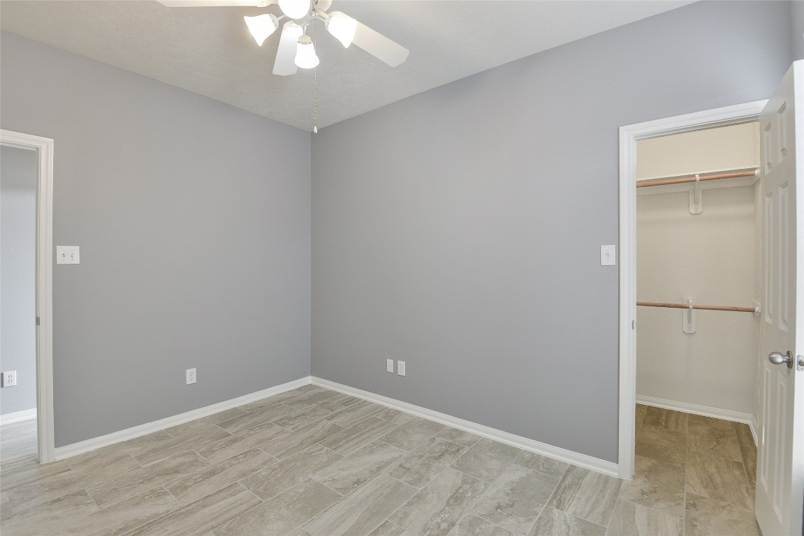 18411 Atasca Wds Trace Humble, TX 77346 - Photo 35 of 44 an empty room with wooden floor and hallway