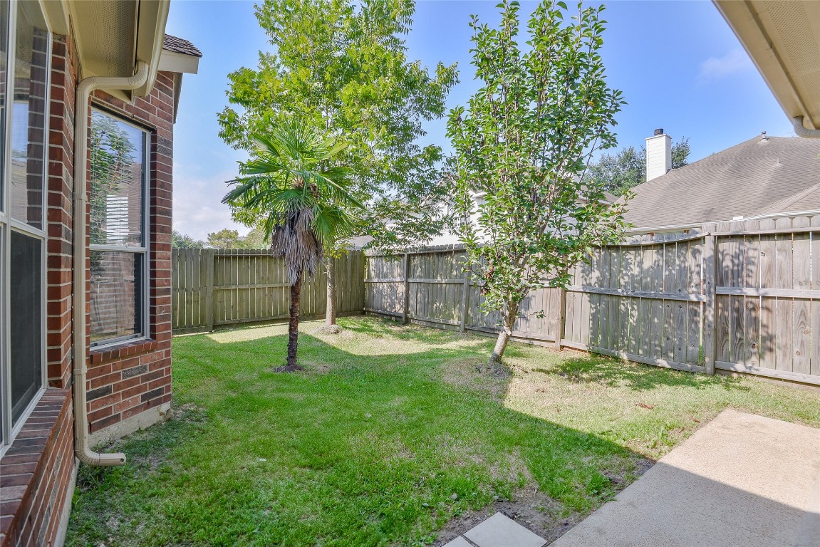 18411 Atasca Wds Trace Humble, TX 77346 - Photo 43 of 44 a view of a backyard with a small cabin and wooden fence