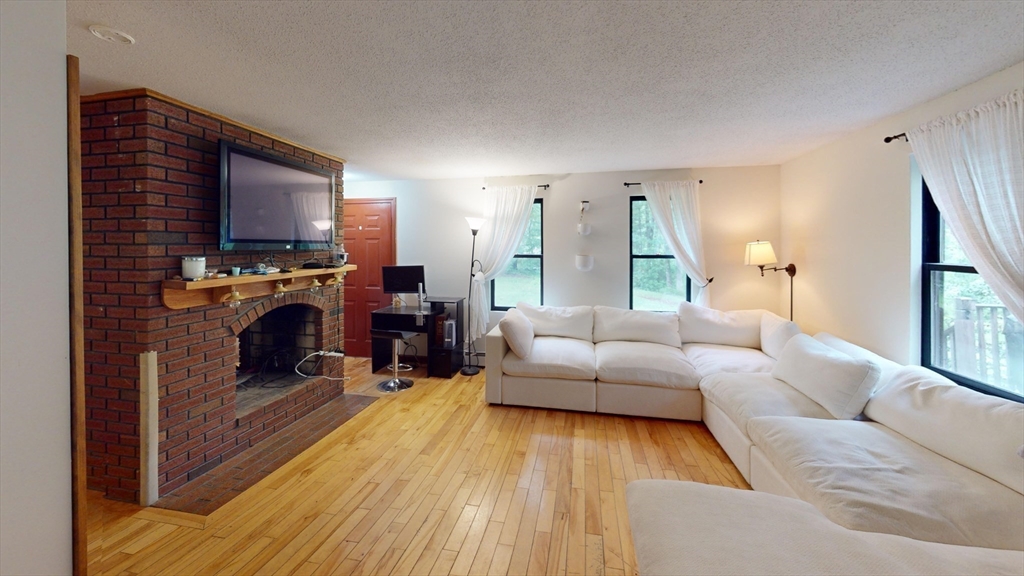 330 Arbor Street Lunenburg, MA 01462 - Photo 14 of 33 a living room with furniture and a fireplace