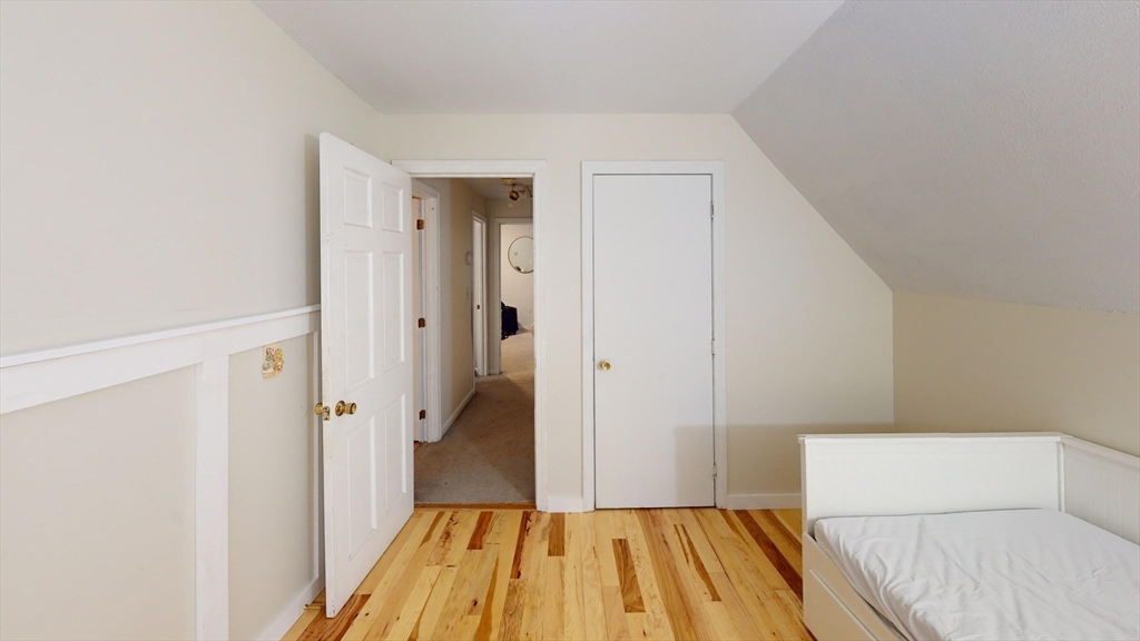 330 Arbor Street Lunenburg, MA 01462 - Photo 19 of 33 a view of a bedroom with wooden floor and a hallway